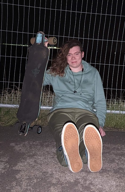 A photo of me with my longboard